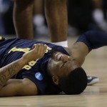 North Carolina A&T forward Adrian Powell (1) lies on the court after being injured during the second half their second-round NCAA college basketball tournament game against Louisville, Thursday, March 21, 2013, in Lexington, Ky. Louisville won 79-48. (AP Photo/John Bazemore)