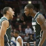 Michigan State guard Denzel Valentine (45) talks to Branden Dawson after Michigan State started with a 10-0 run against Kentucky during an NCAA college basketball game Tuesday, Nov. 12, 2013, in Chicago. (AP Photo/Charles Rex Arbogast)