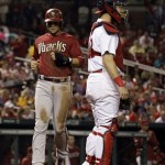 Arizona Diamondbacks' Martin Prado, left, scores on a single by Wil Nieves as St. Louis Cardinals catcher Tony Cruz, right, stands by during the seventh inning of a baseball game on Wednesday, June 5, 2013, in St. Louis. (AP Photo/Jeff Roberson)