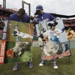 Los Angeles Dodgers' Yasiel Puig and Adrian Gonzalez hold up signs they autographed before Game 6 of the National League baseball championship series against the St. Louis Cardinals, Friday, Oct. 18, 2013, in St. Louis. (AP Photo/Charlie Neibergall)