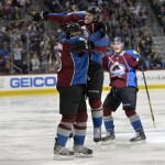  Colorado Avalanche center Nathan MacKinnon (29) jumps on Nate Guenin (5) as Tyson Barrie (4) cheers following Guenin's goal against the Phoenix Coyotes while during the third period of an NHL hockey game on Friday, Feb. 28, 2014, in Denver. (AP Photo/Jack Dempsey)