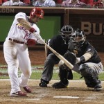 St. Louis Cardinals' Jon Jay drives in Matt Holliday with a single in the sixth inning against the Pittsburgh Pirates in Game 5 of a National League baseball division series on Wednesday, Oct. 9, 2013, in St. Louis. Catching for the Pirates is Russell Martin. (AP Photo/Sarah Conard)
