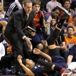  New Orleans Pelicans' Anthony Davis falls into his bench after being fouled against the Phoenix Suns during the second half of an NBA basketball game, Friday, Feb. 28, 2014, in Phoenix.(AP Photo/Matt York)