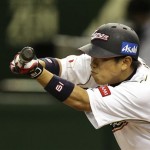 Japan's Katsuya Kakunaka bunts into a force out in the eighth inning of their World Baseball Classic second round game against the Netherlands at Tokyo Dome in Tokyo, Tuesday, March 12, 2013. (AP Photo/Toru Takahashi)