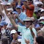 A spectator shows off a ball hit into the grandstand by Ernie Els, of South Africa, on the 17th hole during the third round of the U.S. Open golf tournament at Merion Golf Club, Saturday, June 15, 2013, in Ardmore, Pa. (AP Photo/Julio Cortez)
