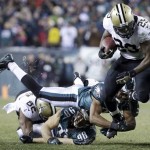 New Orleans Saints' Khiry Robinson, right, tries to get past a diving Philadelphia Eagles' Bradley Fletcher during the second half of an NFL wild-card playoff football game, Saturday, Jan. 4, 2014, in Philadelphia. (AP Photo/Matt Rourke)
