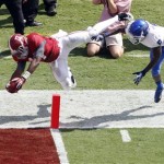 Alabama running back Kenyan Drake (17) dives over the goal line past Georgia State cornerback Demarius Matthews (5) for a touchdown in the first half of an NCAA college football game on Saturday, Oct. 5, 2013, in Tuscaloosa, Ala. (AP Photo/Butch Dill)