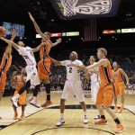 Colorado's Askia Booker (0) shoots against Oregon State's Eric Moreland (15) and Devon Collier (44) in the first half during a Pac-12 tournament NCAA college basketball game on Wednesday, March 13, 2013, in Las Vegas. Colorado won 74-68. (AP Photo/Julie Jacobson)