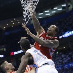 Houston Rockets center Greg Smith (4) dunks in front of teammate Jeremy Lin (7) and Oklahoma City Thunder forward Serge Ibaka (9) in the second quarter of Game 2 of their first-round NBA basketball playoff series in Oklahoma City, Wednesday, April 24, 2013. (AP Photo/Sue Ogrocki)