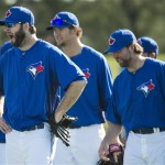 Toronto Blue Jays starting pitcher Brandon Morrow, left, yawns in front of Josh Johnson, center, and R.A. Dickey, right, as they take part in a drill during baseball spring training in Dunedin, Fla., on Friday, Feb. 22, 2013. (AP Photo/The Canadian Press, Nathan Denette)