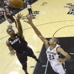 Miami Heat's Chris Bosh shoots over San Antonio Spurs' Tim Duncan (21) during the first half at Game 4 of the NBA Finals basketball series, Thursday, June 13, 2013, in San Antonio. (AP Photo/Derick E. Hingle)