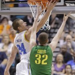UCLA's Travis Wear goes up for a shot against Oregon's Ben Carter in the first half of the NCAA college basketball game in the Pac-12 Conference tournament, Saturday, March 16, 2013, in Las Vegas. (AP Photo/Julie Jacobson)
