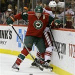  Minnesota Wild defenseman Ryan Suter (20) pins Phoenix Coyotes center Mike Ribeiro (63) against the boards as they chase the puck during the second period of an NHL hockey game in St. Paul, Minn., Wednesday, Nov. 27, 2013. (AP Photo/Ann Heisenfelt)