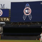 New York Yankees players observe a moment of silence in memory of the victims of the Boston Marathon explosions before a baseball game against the Arizona Diamondbacks at Yankee Stadium in New York, Tuesday, April 16, 2013. (AP Photo/Kathy Willens)