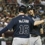 Atlanta Braves' Chris Johnson celebrates his home run against the Arizona Diamondbacks with teammate Brian McCann during the fifth inning of a baseball game, on Monday, May 13, 2013, in Phoenix. (AP Photo/Ross D. Franklin)