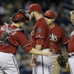 Arizona Diamondbacks catcher Miguel Montero (26) consoles starting pitcher Wade Miley, second from left, who loaded the bases and walked in a run in the seventh inning, as teammates surround Miley in a baseball game against the New York Yankees at Yankee Stadium in New York, Wednesday, April 17, 2013. (AP Photo/Kathy Willens)
