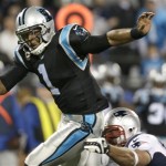 Carolina Panthers' Cam Newton (1) avoids a sack by a New England Patriots defender during the second half of an NFL football game in Charlotte, N.C., Monday, Nov. 18, 2013. (AP Photo/Bob Leverone)