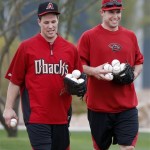 Arizona Diamondbacks' Paul Goldschmidt, right, and Blake Lalli pick up baseballs after an informal workout with teammates a day prior to MLB spring training baseball starting for pitchers and catchers at the Diamondbacks training facility, Thursday, Feb. 6, 2014, in Scottsdale, Ariz. (AP Photo/Ross D. Franklin)
