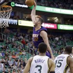  Phoenix Suns' Miles Plumlee (22) dunks the ball as Utah Jazz's Trey Burke (3) and teammate Derrick Favors (15) look on in the first quarter of an NBA basketball game on Wednesday, Feb. 26, 2014, in Salt Lake City. (AP Photo/Rick Bowmer)