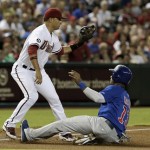 Chicago Cubs' Starlin Castro, right, slides safely into third base on a fly ball by teammate Anthony Rizzo as Arizona Diamondbacks' Martin Prado waits for a late throw in the first inning of a baseball game on Monday, July 22, 2013, in Phoenix. (AP Photo/Ross D. Franklin)