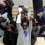 Baltimore Ravens wide receiver Torrey Smith, center, holds the Vince Lombardi championship trophy during a parade and celebration of the team's NFL football Super Bowl championship in Baltimore on Tuesday, Feb. 5, 2013. The Ravens defeated the San Francisco 49ers 34-31 on Sunday in New Orleans. (AP Photo/Steve Ruark)