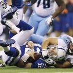 Indianapolis Colts' Andrew Luck (12) is sacked by Tennessee Titans' Karl Klug (97) during the first half of an NFL football game Sunday, Dec. 9, 2012, in Indianapolis. (AP Photo/Jeff Roberson)
