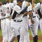 U.S. manager Joe Torre, foreground, high-fives players during a World Baseball Classic game against Puerto Rico at Marlins Park on Tuesday, March 12, 2013, in Miami. The United States defeated Puerto Rico 7-1. (AP Photo/Mike Ehrmann, Pool)