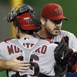 Arizona Diamondbacks starting pitcher Joe Saunders, right, hugs catcher Miguel Montero (26) after pitching a complete game shutout to defeat the Miami Marlins 5-0 during a baseball game in Miami, Friday, April 27, 2012.( AP Photo/Lynne Sladky)