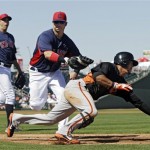  Cleveland Indians right fielder Nick Swisher, center, tags out San Francisco Giants' Gregor Blanco on a bunt in the fourth inning of an exhibition spring training baseball game, Thursday, March 7, 2013, in Goodyear, Ariz. Starting pitcher Ubaldo Jimenez, left, trails the play. (AP Photo/Mark Duncan)
