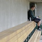 Oakland Athletics' Brett Anderson checks the messages on his phone after reporting to baseball spring training Monday, Feb. 11, 2013, in Phoenix. (AP Photo/Darron Cummings)