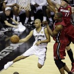 San Antonio Spurs point guard Tony Parker (9) passes the ball around Miami Heat forward Chris Andersen and center Chris Bosh (1) during the first half at Game 3 of the NBA Finals basketball series, Tuesday, June 11, 2013, in San Antonio. (AP Photo/David J. Phillip)