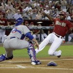 Arizona Diamondbacks' Justin Upton, right, slides home safely in the first inning in front of Chicago Cubs catcher Anthony Recker during a baseball game Sunday, Sept. 30, 2012, in Phoenix. (AP Photo/Rick Scuteri)