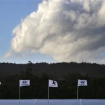 Tournament flags flutter horizontally as clouds billow behind before the first round at the Tournament of Champions PGA golf tournament, Sunday, Jan. 6, 2013, in Kapalua, Hawaii. Play was to have started two days earlier, but was delayed because of rain and high winds. (AP Photo/Elaine Thompson)