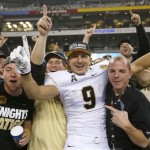 Central Florida's J.J. Worton (9) celebrates in the stands with fans after the Fiesta Bowl NCAA college football game win against Baylor Wednesday, Jan. 1, 2014, in Glendale, Ariz. Central Florida defeated Baylor 52-42. (AP Photo/Ross D. Franklin)