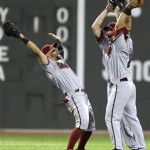 Arizona Diamondbacks right fielder Cody Ross, left, celebrates a 7-6 win with teammates after beating the Boston Red Sox in an interleague baseball game at Fenway Park, Friday Aug. 2, 2013, in Boston. Ross was 4-5 with 2 RBI's in the game. (AP Photo/Charles Krupa)
