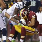 
Washington Redskins running back Evan Royster is hit by Seattle Seahawks strong safety Kam Chancellor as he rolls into the end zone for a touchdown during the first half of an NFL wild card playoff football game in Landover, Md., Sunday, Jan. 6, 2013. (AP Photo/Evan Vucci)