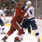 Phoenix Coyotes defenseman Rostislav Klesla, left, of the Czech Republic, checks Tampa Bay Lightning center Dana Tyrell, right, in the first period of an NHL hockey game on Saturday, Jan. 21, 2012, in Glendale, Ariz. (AP Photo/Paul Connors)
