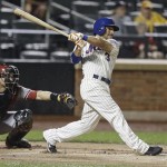 New York Mets' Omar Quintanilla hits a two-run single during the seventh inning of a baseball game against the Arizona Diamondbacks Tuesday, July 2, 2013, in New York. (AP Photo/Frank Franklin II)