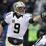 New Orleans Saints quarterback Drew Brees points while at the line of scrimmage during the first quarter of an NFC divisional playoff NFL football game against the Seattle Seahawks in Seattle, Saturday, Jan. 11, 2014. (AP Photo/Elaine Thompson)