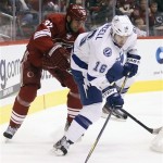 Tampa Bay Lightning right winger Teddy Purcell, right, gains control the puck in front of Phoenix Coyotes defenseman Michal Rozsival, left, of the Czech Republic, in the first period of an NHL hockey game on Saturday, Jan. 21, 2012, in Glendale, Ariz. (AP Photo/Paul Connors)