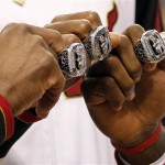 From left, Miami Heat's Dwyane Wade, Chris Bosh and LeBron James pose with their 2012 NBA Finals championship rings during a ceremony before a basketball game against the Boston Celtics, Tuesday, Oct. 30, 2012, in Miami. (AP Photo/The Miami Herald, Charles Trainor Jr.