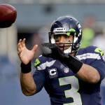 Seattle Seahawks quarterback Russell Wilson warms up before an NFC divisional playoff NFL football game against the New Orleans Saints in Seattle, Saturday, Jan. 11, 2014. (AP Photo/Elaine Thompson)