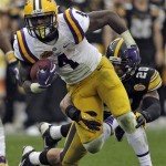 LSU running back Alfred Blue (4) is wrapped up by Iowa linebacker Christian Kirksey (20) during the second quarter of the Outback Bowl NCAA college football game Wednesday, Jan. 1, 2014, in Tampa, Fla. (AP Photo/Chris O'Meara)