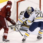  Buffalo Sabres' Ryan Miller (30) makes a save on a shot by Phoenix Coyotes' Martin Hanzal, left, of the Czech Republic, as Sabres' Henrik Tallinder (20), of Sweden, defends during the second period of an NHL hockey game on Thursday, Jan. 30, 2014, in Glendale, Ariz. (AP Photo)