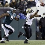New Orleans Saints' Mark Ingram, right, cannot pull in a pass as Philadelphia Eagles' Fletcher Cox (91) pursues during the first half of an NFL wild-card playoff football game, Saturday, Jan. 4, 2014, in Philadelphia. (AP Photo/Julio Cortez)