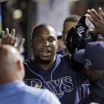Tampa Bay Rays' Delmon Young is greeted in the dugout after a solo home run off Cleveland Indians starting pitcher Danny Salazar in the third inning of the AL wild-card baseball game Wednesday, Oct. 2, 2013, in Cleveland. (AP Photo/Tony Dejak)