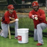 St. Louis Cardinals relief pitcher Jason Motte, right, gestures with his bat while starting pitcher Joe Kelly looks on during spring training baseball, Thursday, Feb. 14, 2013, in Jupiter, Fla. (AP Photo/Julio Cortez)