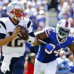 New England Patriots' Tom Brady (12) looks to pass as Buffalo Bills defensive end Mario Williams (94) closes in during the first half of an NFL football game on Sunday, Sept. 8, 2013, in Orchard Park. (AP Photo/Bill Wippert)