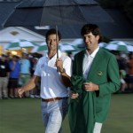 Adam Scott, of Australia, walks with Bubba Watson for the green jacket presentation after winning the Masters golf tournament Sunday, April 14, 2013, in Augusta, Ga. (AP Photo/Charlie Riedel)
