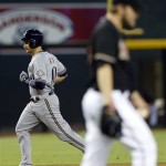 Milwaukee Brewers' Jonathan Lucroy, left, rounds the bases after hitting a two-run home run off Arizona Diamondbacks' Wade Miley, right, during the first inning of a baseball game on Thursday, July 11, 2013, in Phoenix. (AP Photo/Matt York)